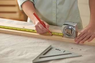 Making marks on lumber to create a DIY rolling storage space option