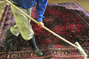 men rinsing rug