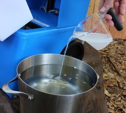 Pouring rug cleaning fluid into Two Gallon Pot Pouring Carpet Cleaning fluid into Two Gallon Pot
